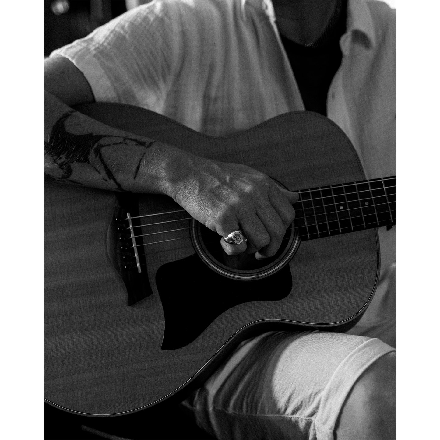 Person holding guitar wearing Hold Fast ring