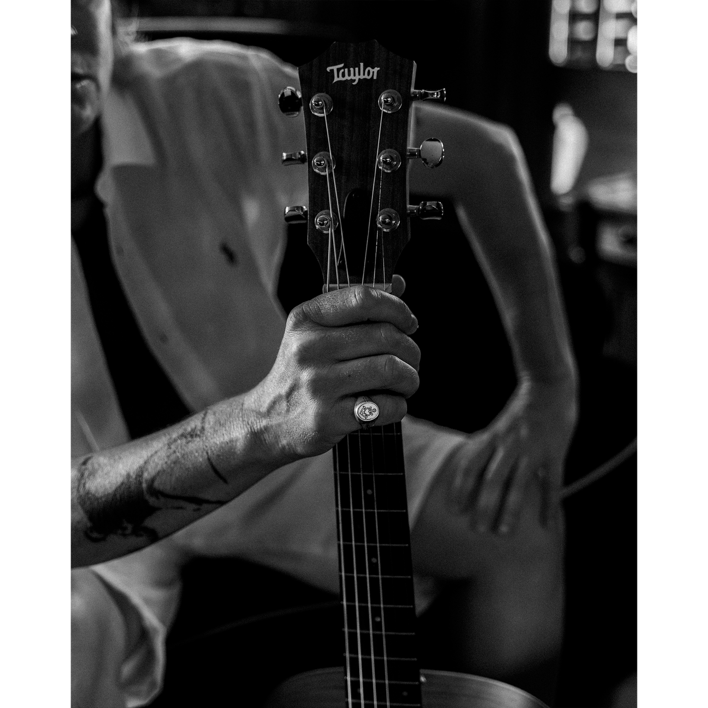 Person holding guitar wearing the Hold Fast Ring