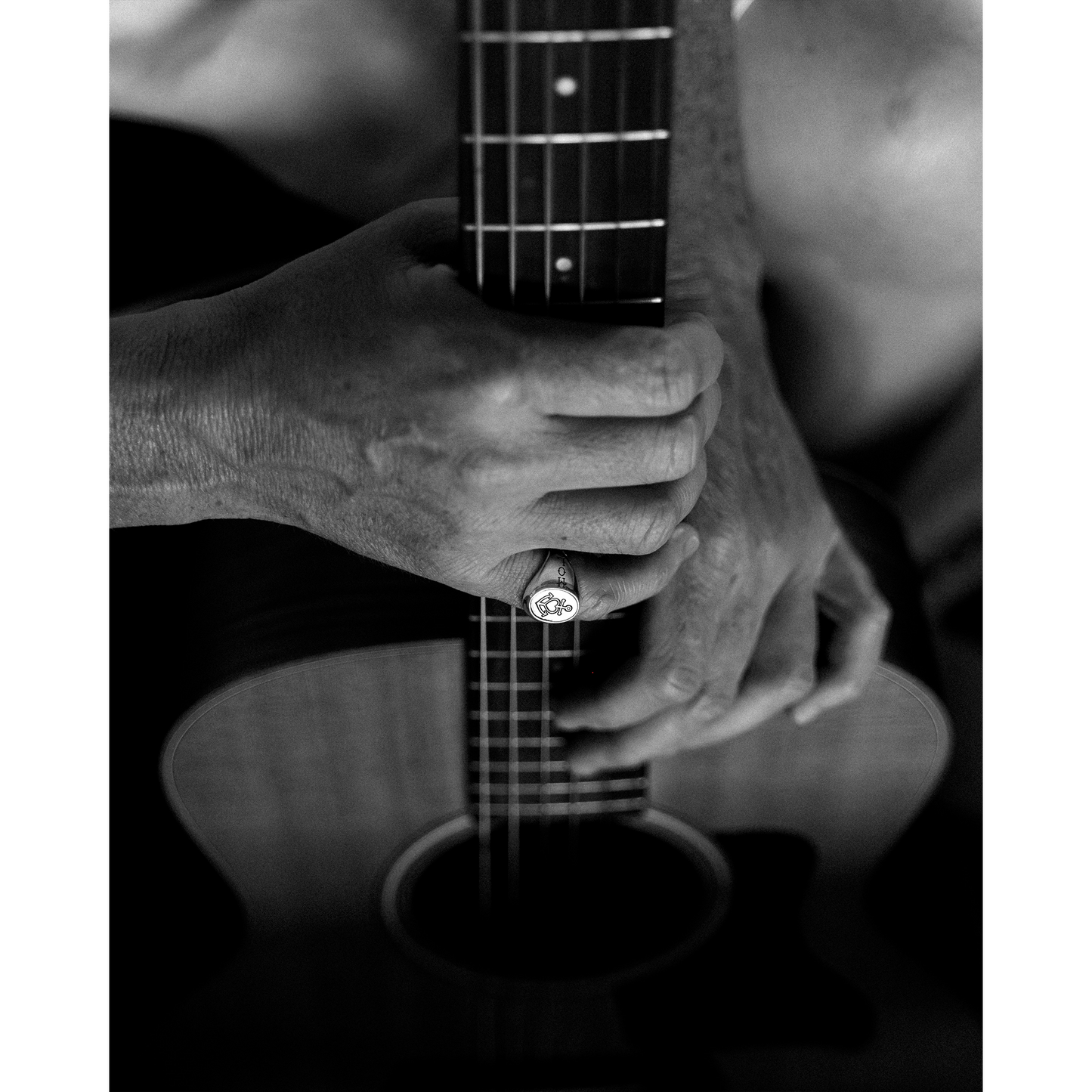 Person holding guitar wearing the Hold Fast ring