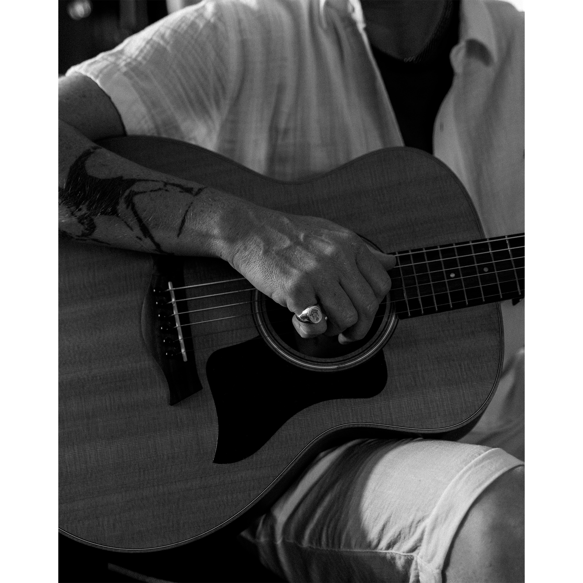 Person holding guitar wearing Hold Fast ring 