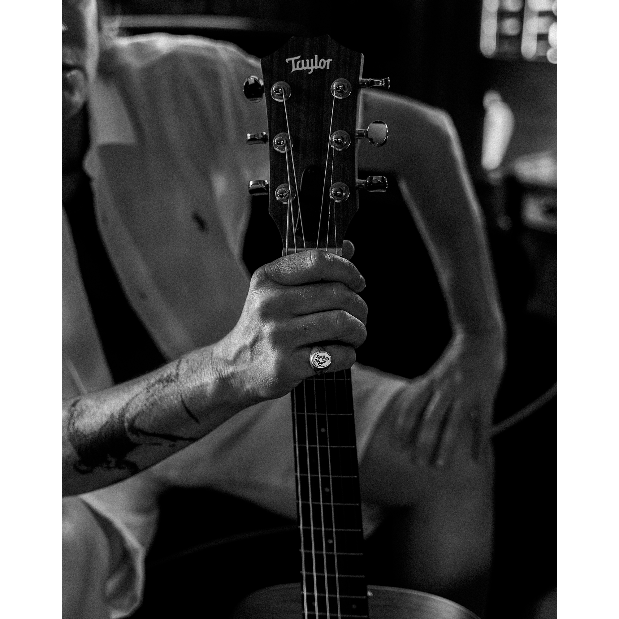 Person holding guitar wearing the Hold Fast Ring